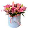 a stunning blend of colorful lilies, alstroemeria, aster, seasonal fillers, and lush greenery