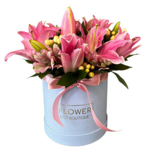 a stunning blend of colorful lilies, alstroemeria, aster, seasonal fillers, and lush greenery